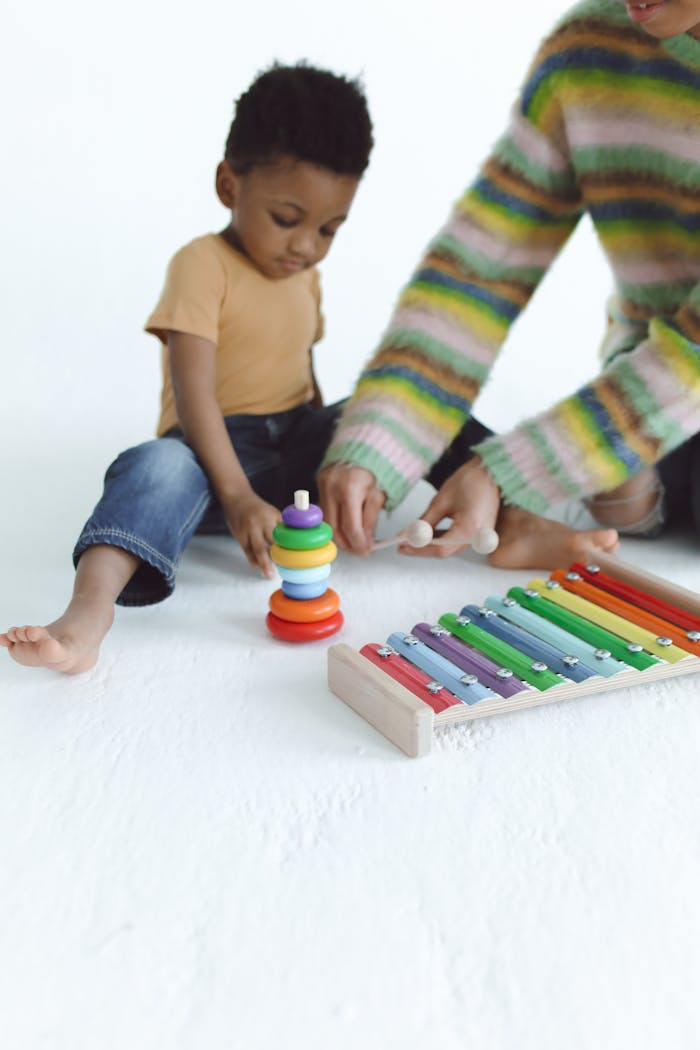 Crafting Captivating Headlines: Your awesome post title goes here A mother and child enjoying creative playtime with colorful toys, fostering education and bonding.